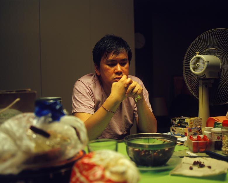 Zack, an entrepreneur, sits in his kitchen in Kai Yuen Street, North Point.