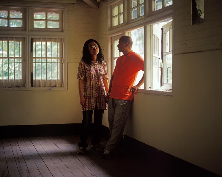 Mr. and Mrs. Chan stand in what used to be their kitchen when they lived in these employee quarters of the Government Supplies Department on Oil Street, North Point in the 1990s. Mr Chan was a driver for the Department.
